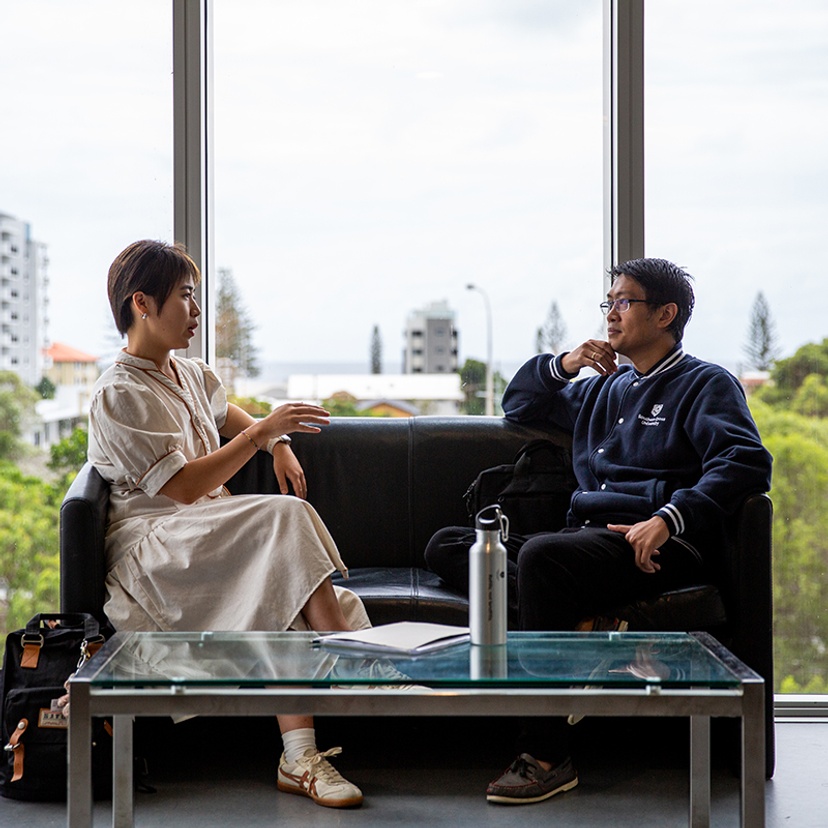 Postgraduate students Yolanda Zong and Roland Yap sitting in Building B at the Gold Coast campus