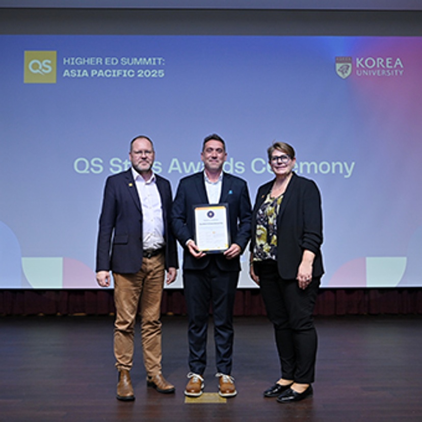 Renaud accepting award at QS Stars ceremony in South Korea