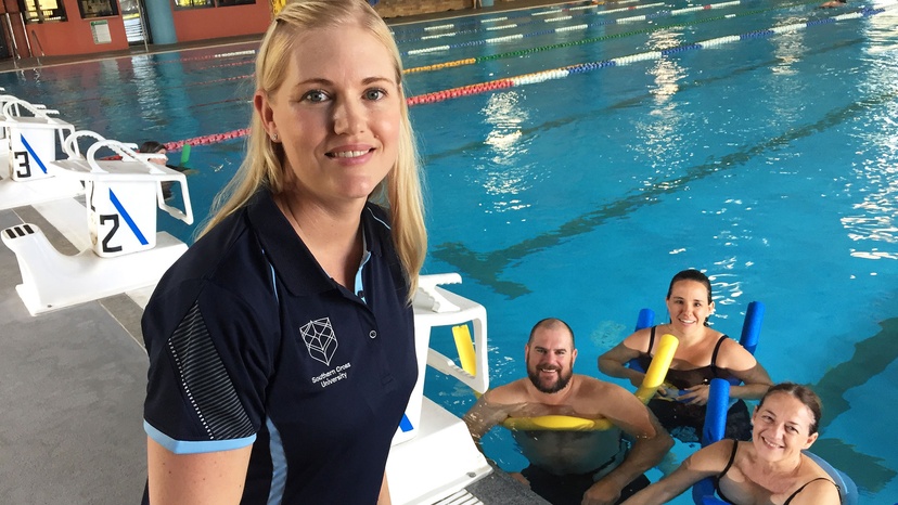 Blonde female at pool with three swimmers