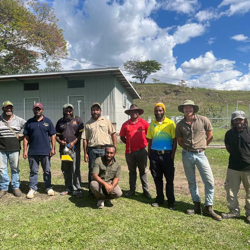 Ten men in rural setting