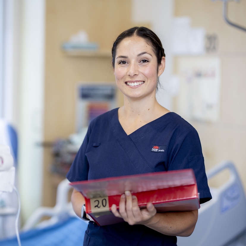 medical person standing looking at camera smiling
