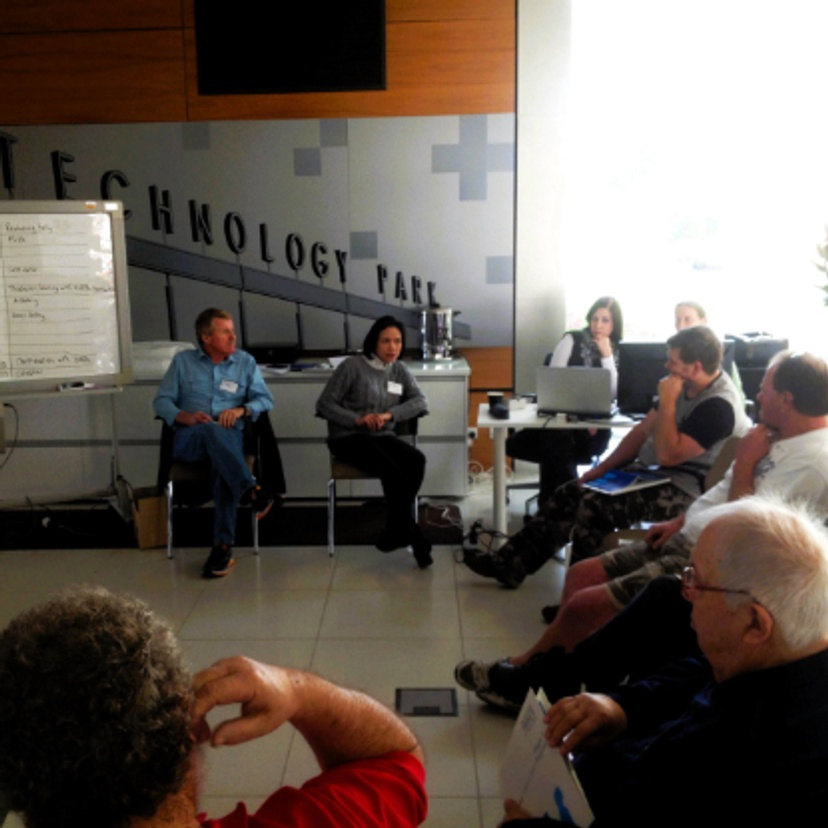 A group of people sitting on chairs in a meeting