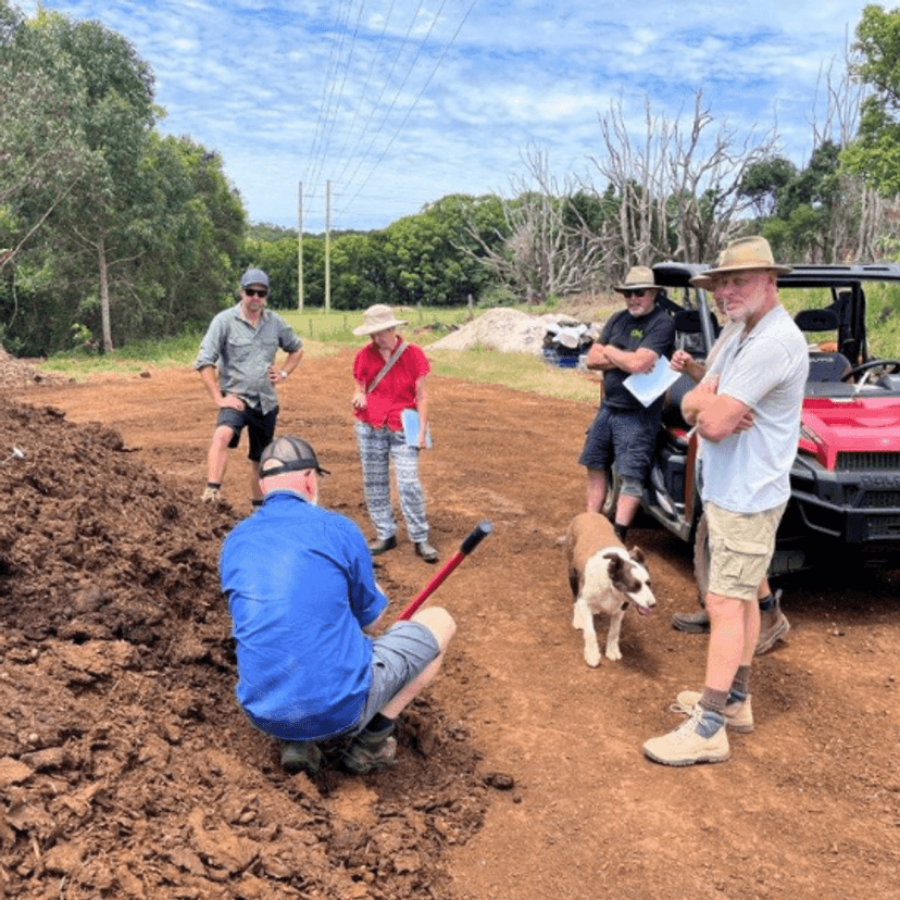 Farmers inspecting soils during a field day.