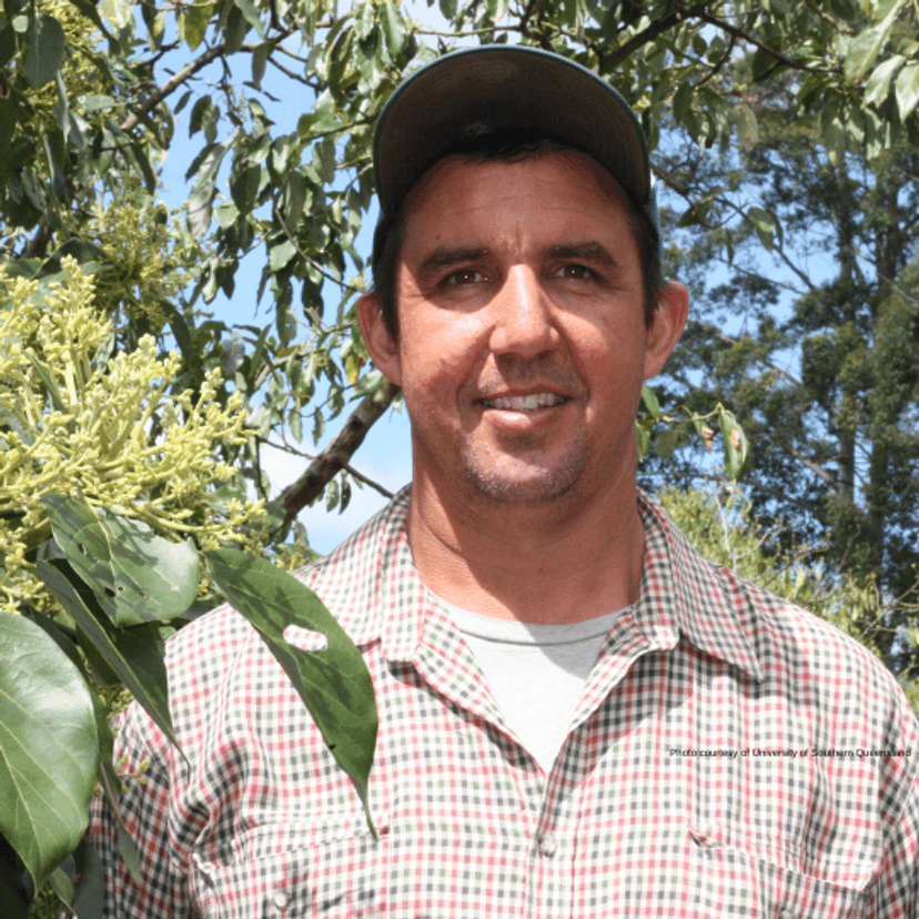 Smiling farmer wearing a cap.