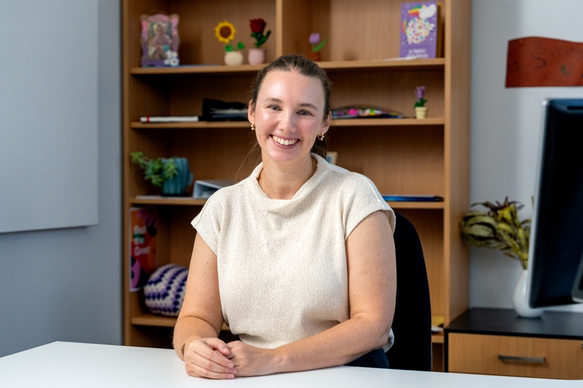 A staff member sitting at des
