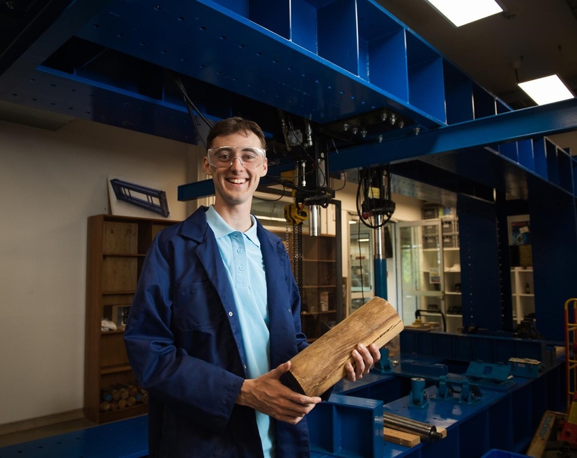 student holding timber in engineering labs