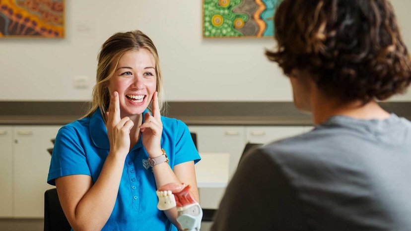 Speech pathology student with client