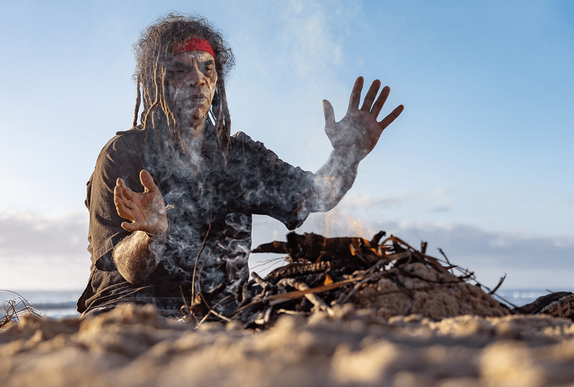 Gumbaynggirr Elder, Uncle Michael ‘Micklo’ Jarrett sitting by fire