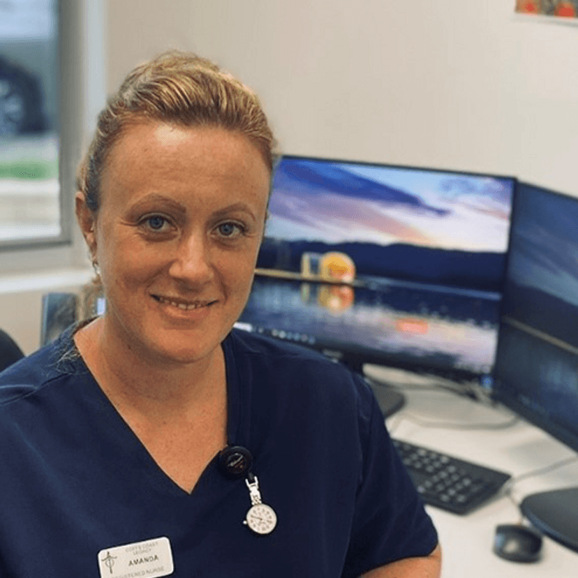 Nurse Amanda Christie sitting at work desk