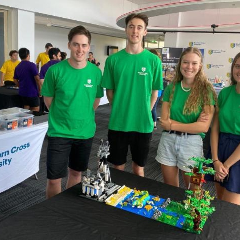 Group of 4 students with exhibit