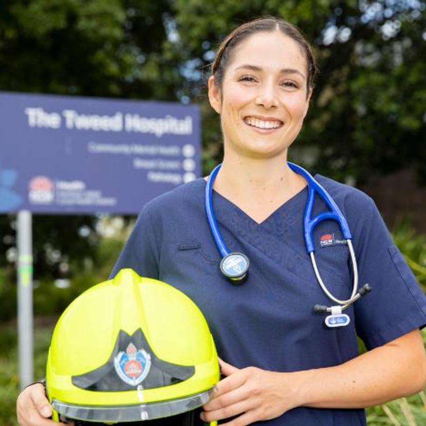 Bachelor of Nursing graduate Sophie Longworth at the front of the Tweed Hospital holding fire fighter helmet