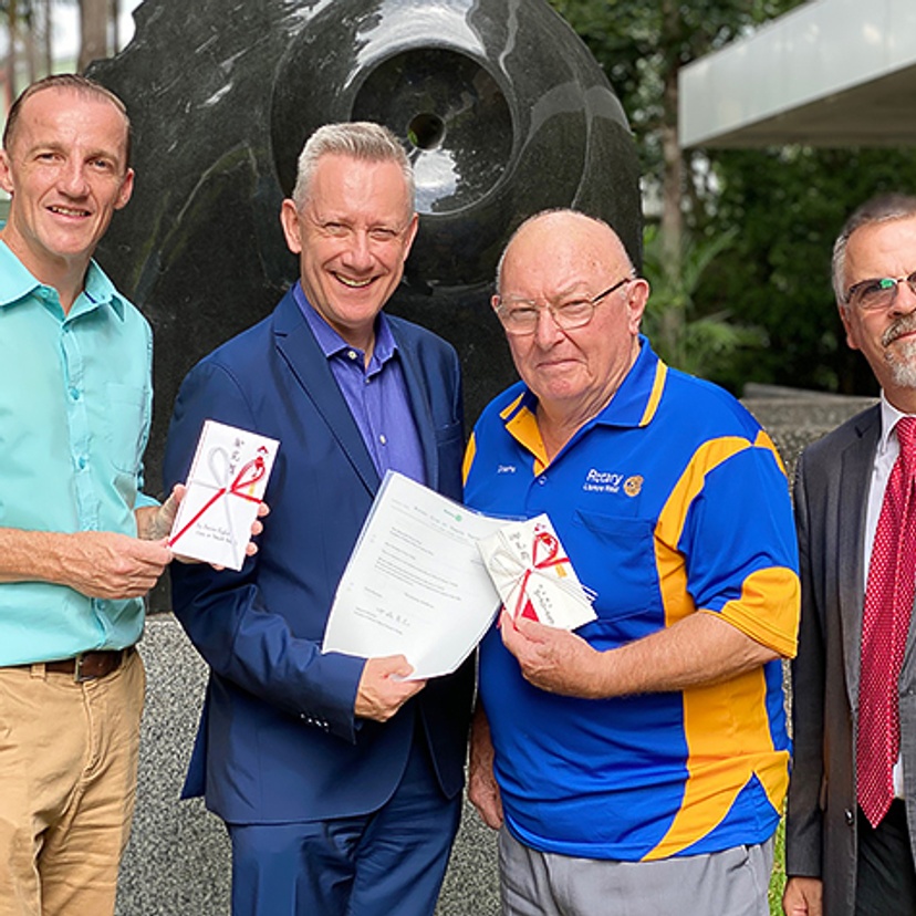 Lismore Mayor Isaac Smith, Vice Chancellor Professor Adam Shoemaker, Lismore West Rotary Secretary Graeme Hargreaves and Professor Peter Wilson accepting donations from the people of Yamato Takada to Lismore for bushfire relief.