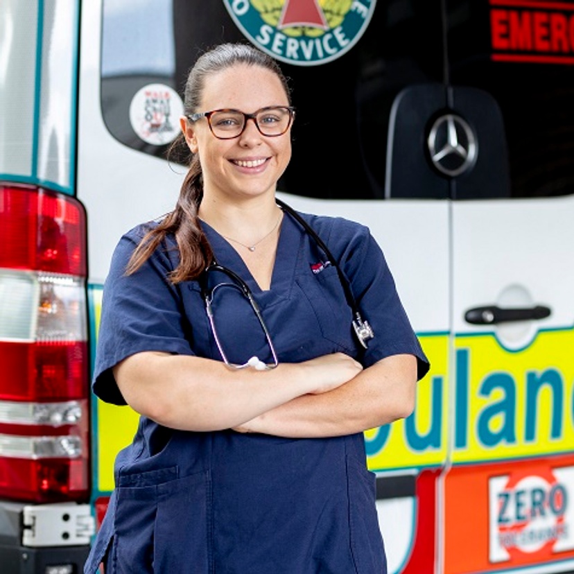 Nurse standing in front of an ambulance