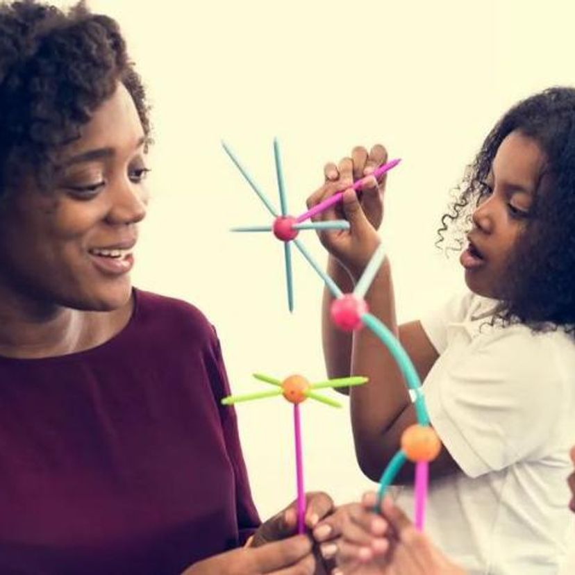 Adult African woman playing with three African children