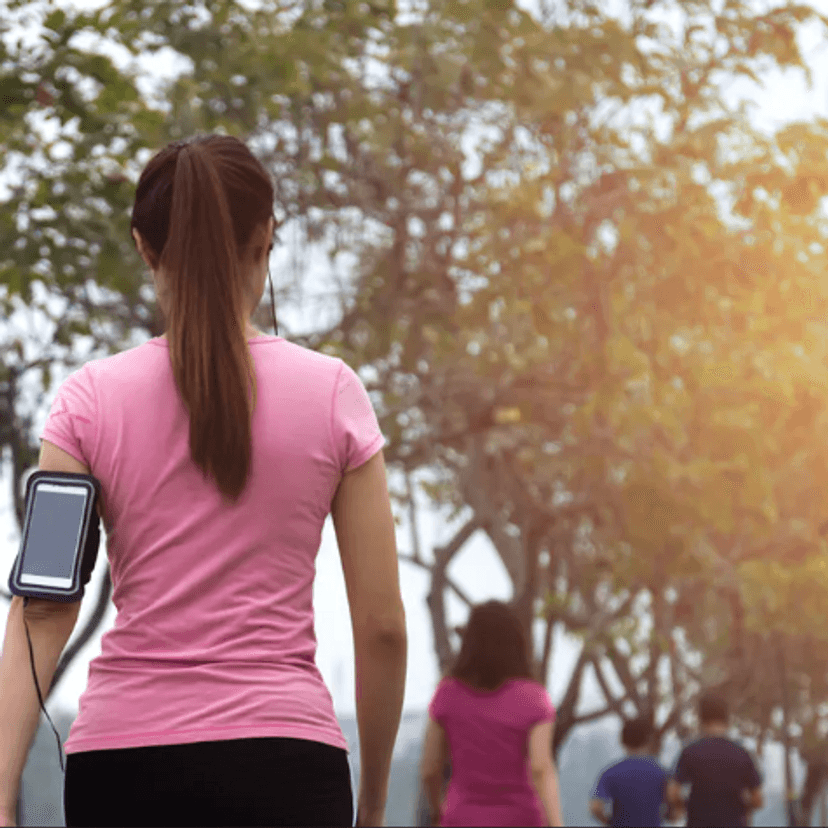 Woman exercising in a park with other people