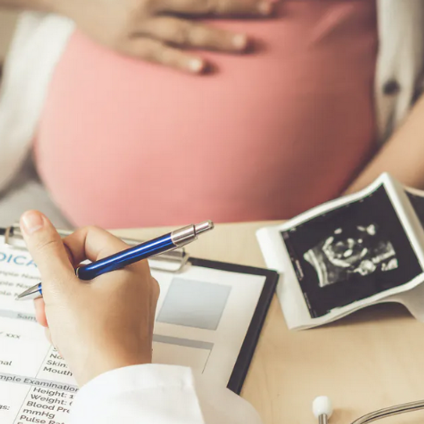 Pregnant woman with scans of womb
