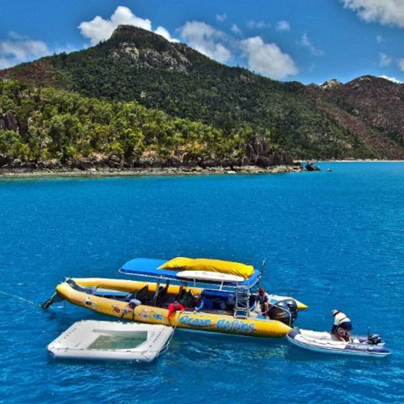 Boat in the ocean towing a coral larvae nursery pool