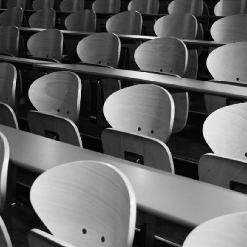 Rows of desks and chairs in a classroom