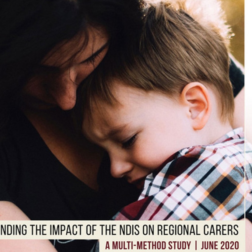 Young boy held by carer