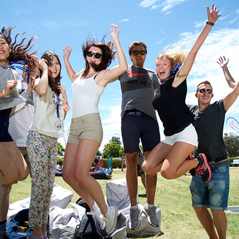 happy group of students jumping in the air