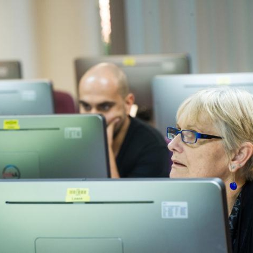 Two students sitting in front of computers