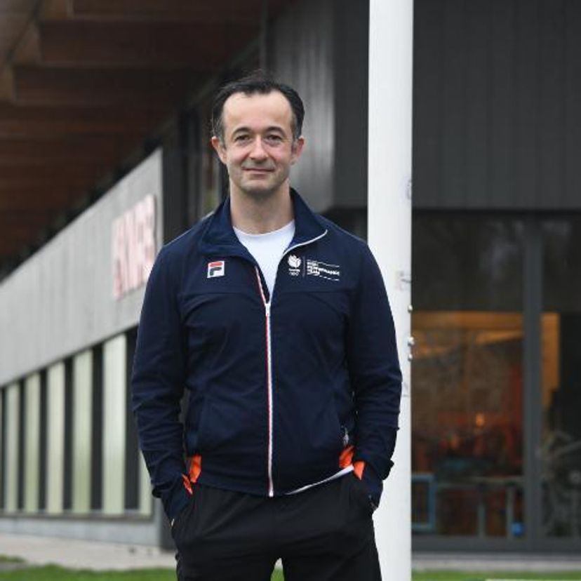 A man standing outside a building in winter time