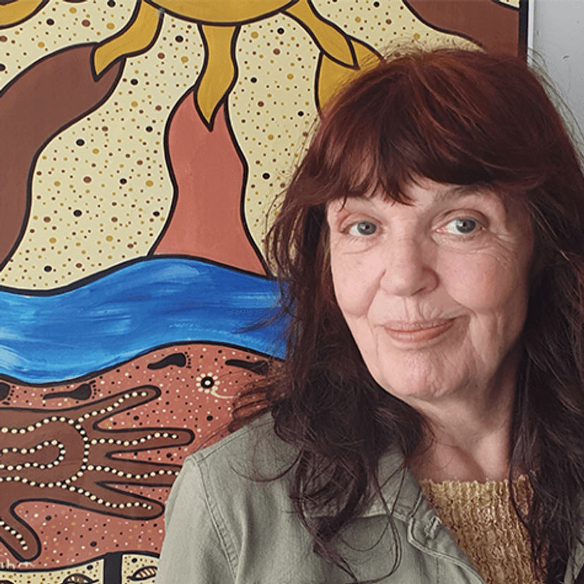 Dr Liz Rix in front of Indigenous artwork