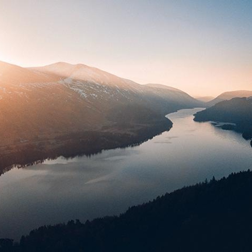 A river and mountain landscape at dawn
