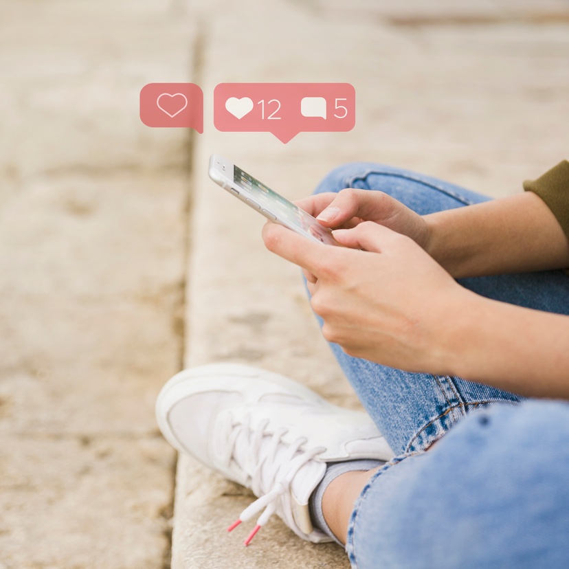 Young adult uses social media on mobile phone