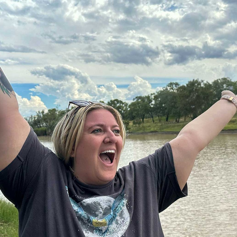 Student in front of brown river