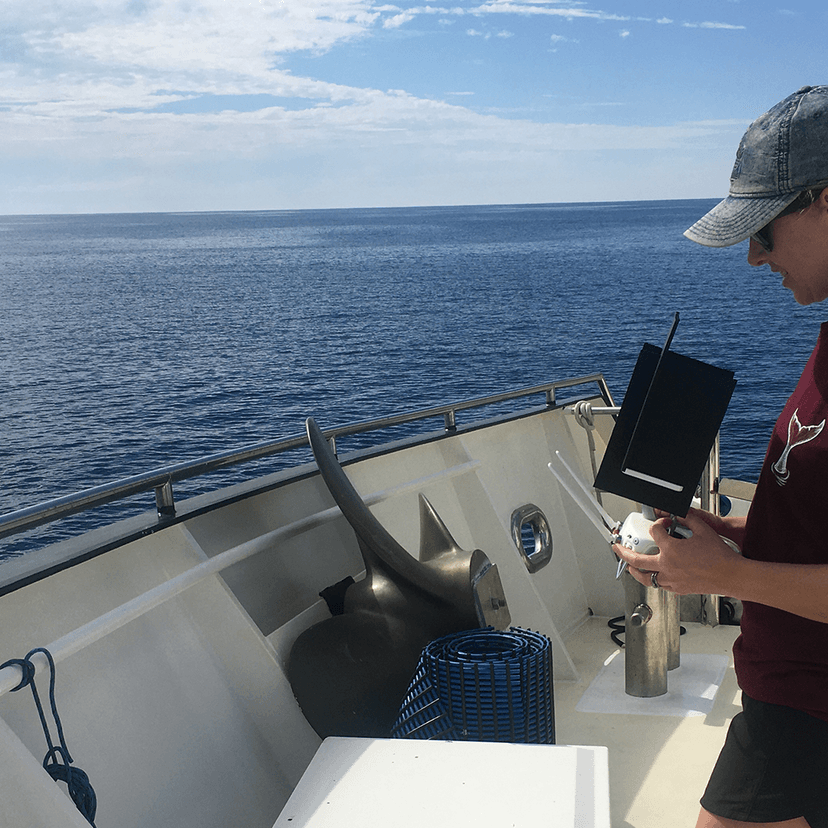 Woman on boat using drone