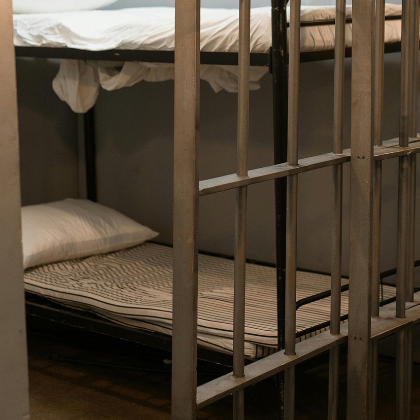Bunk beds behind bars in prison