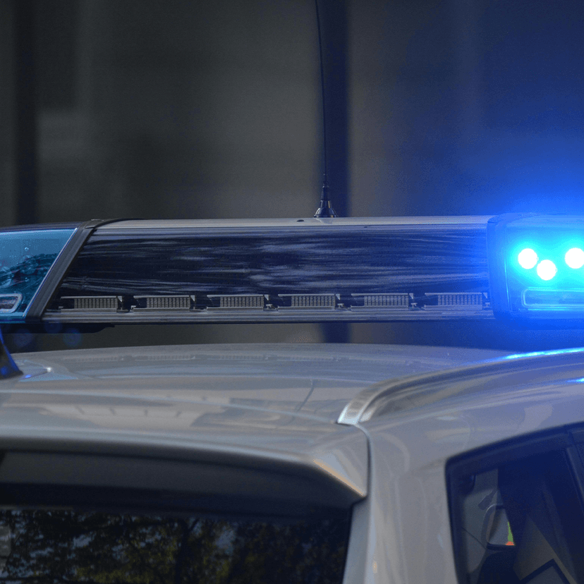 Blue lights flashing on top of police car
