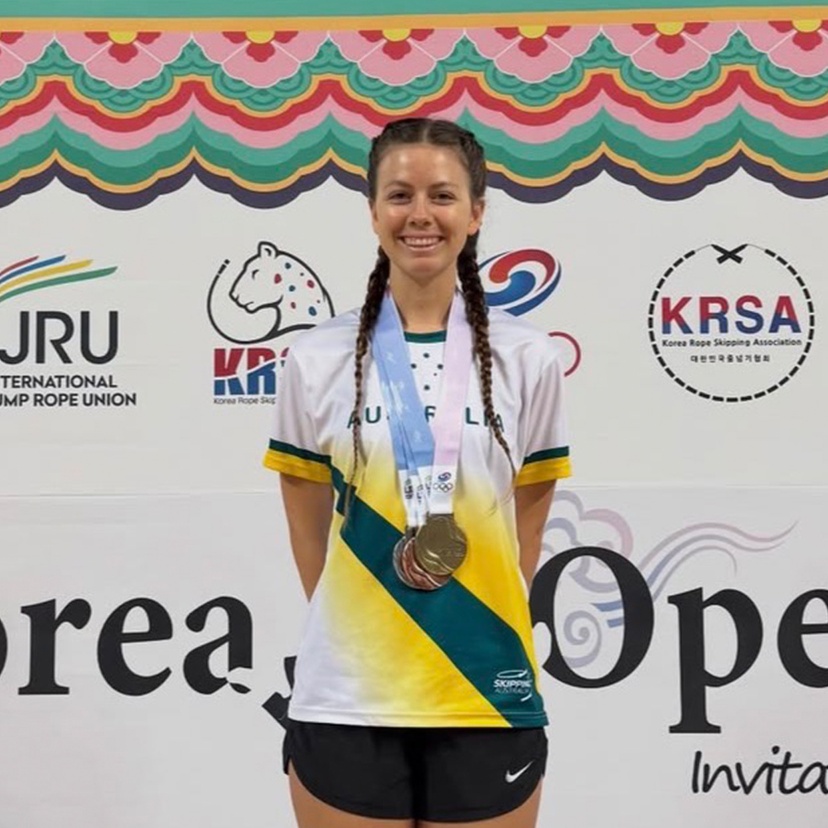 Student in athletic gear with medal