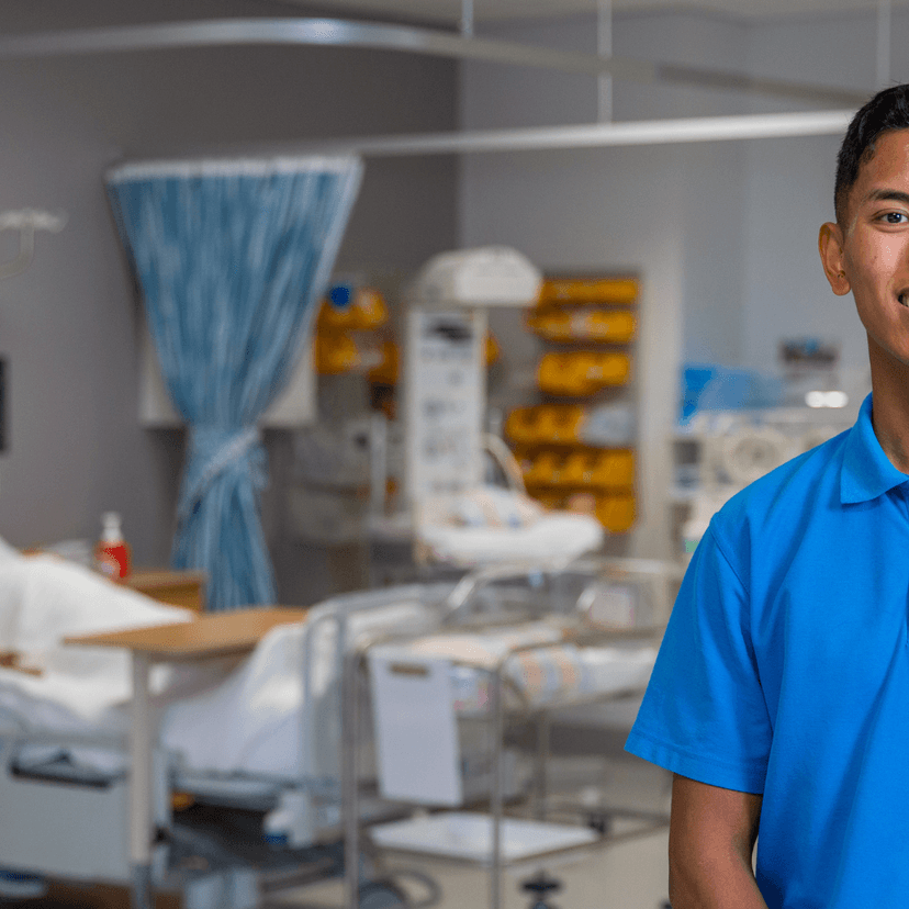 Nurse John Palencia faces camera in a hospital ward