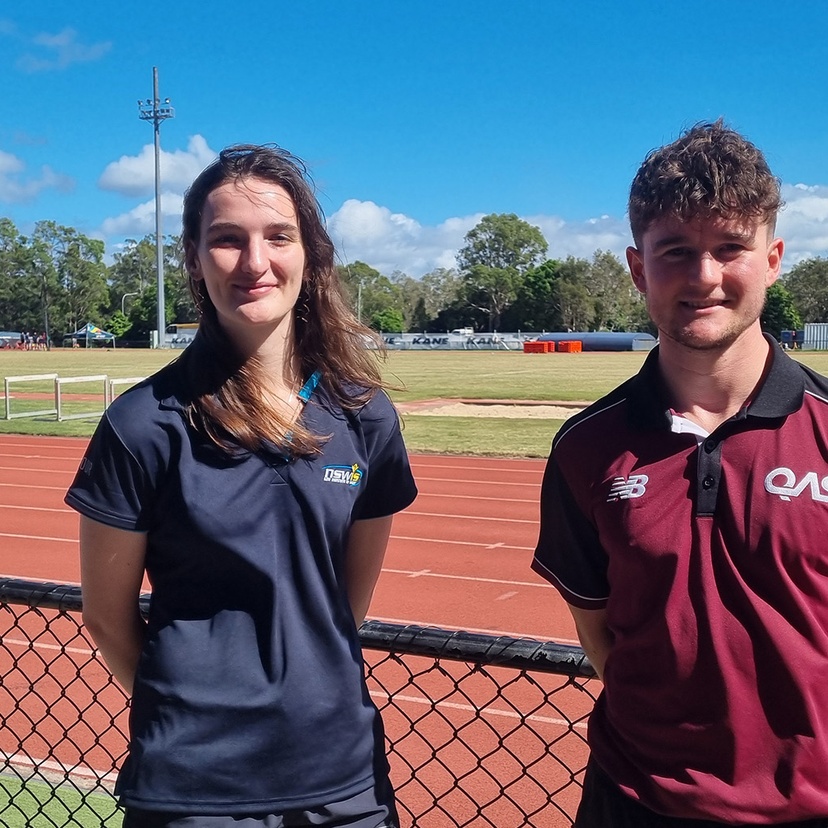 A woman and man standing in front of running track