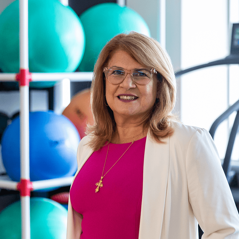 Woman in physio room with treadmill and exercise balls