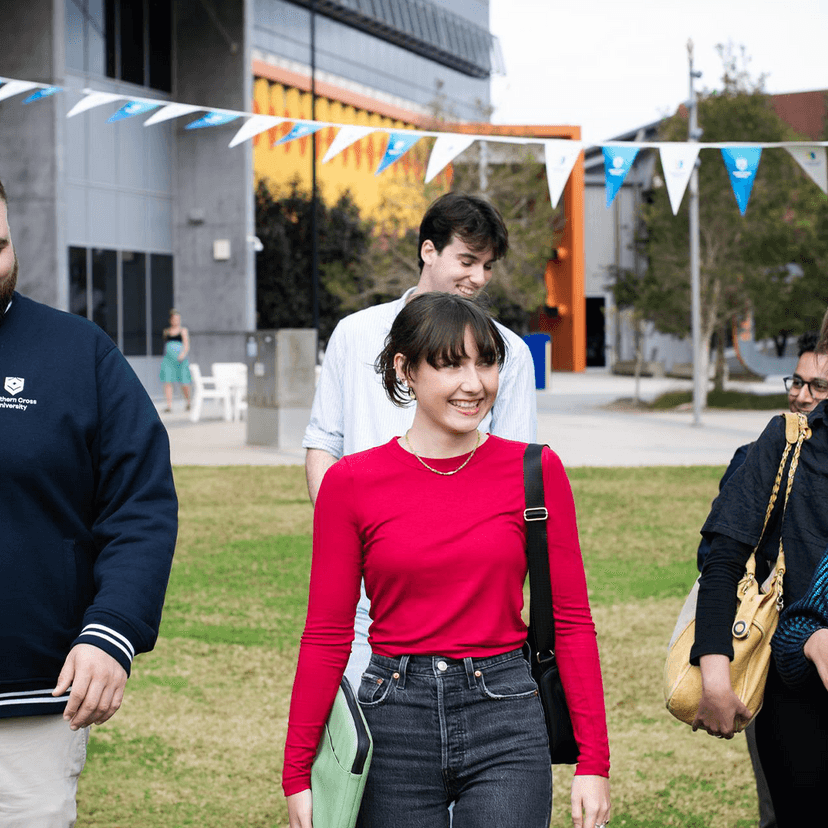 Students walking in grassy field at Gold Coast campus