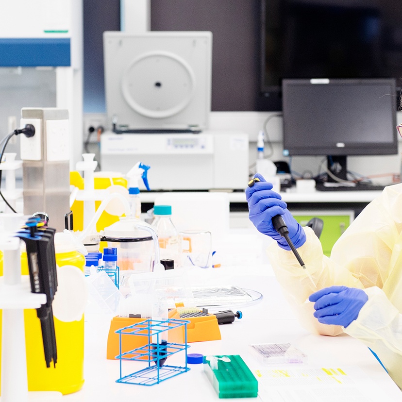 A woman with a pipette in a health laboratory