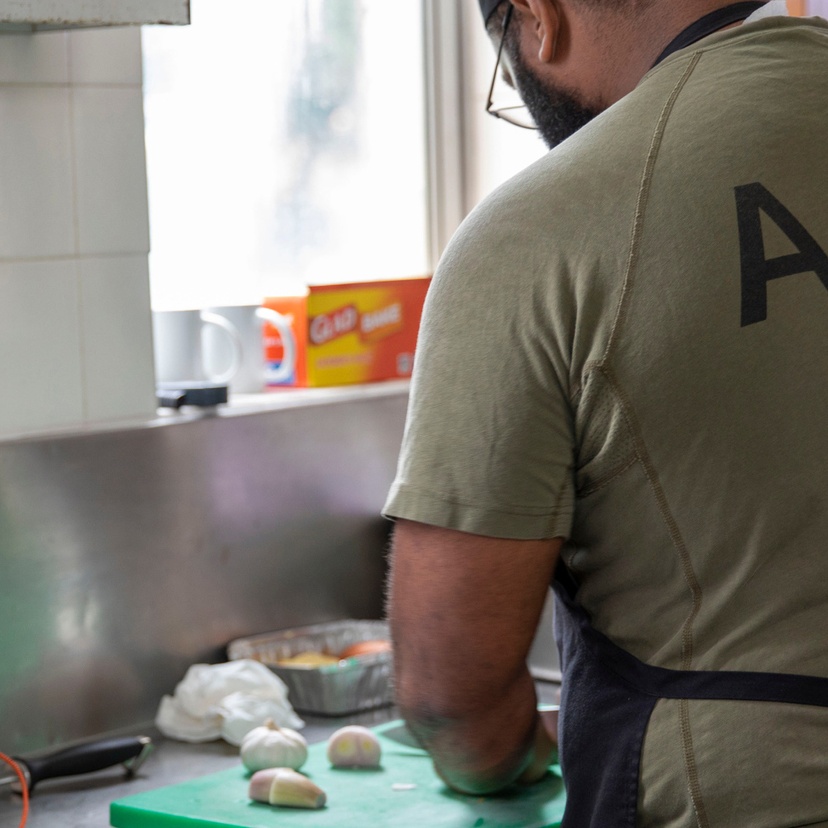 A navy officer prepares food at a military barracks.