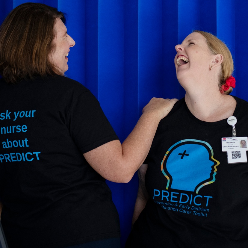 Two women in a hospital ward with PREDICT tshirts for delirium awareness
