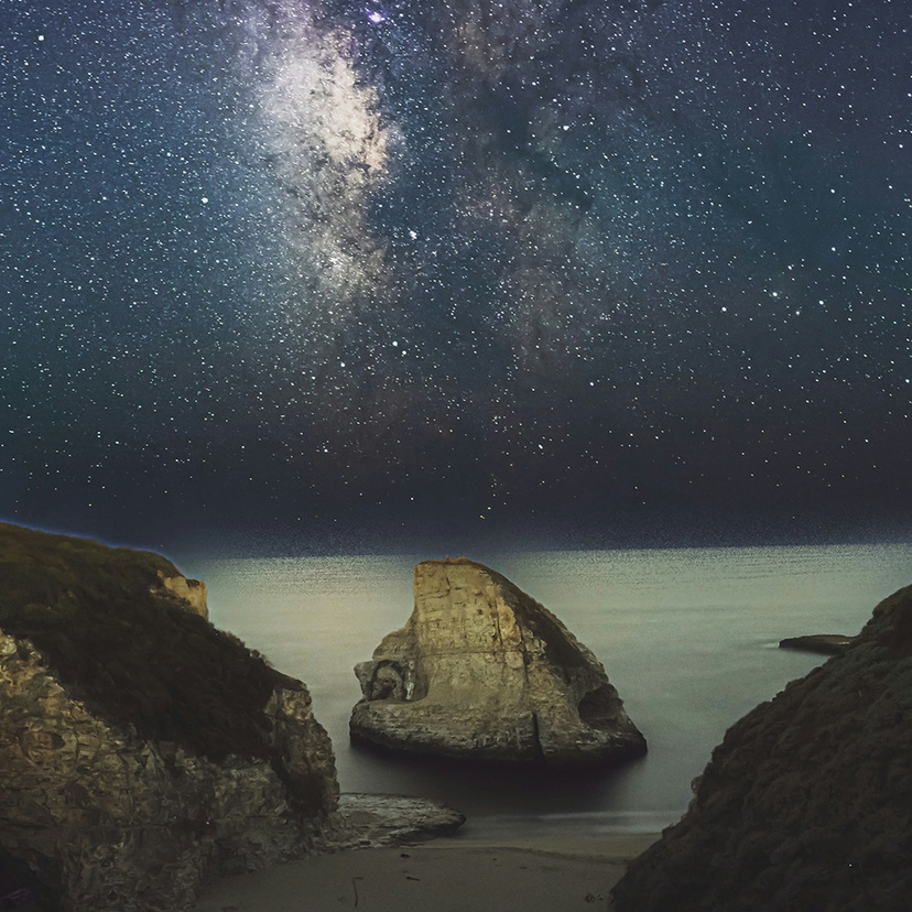 A night sky with milky way observed from a beach