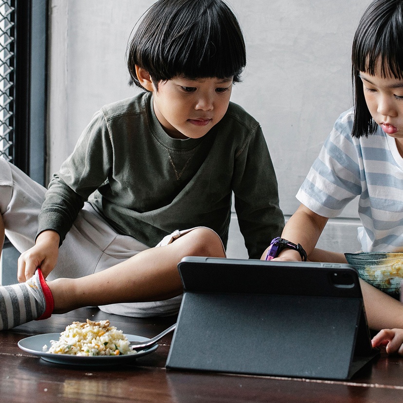 Two children using a digital tablet
