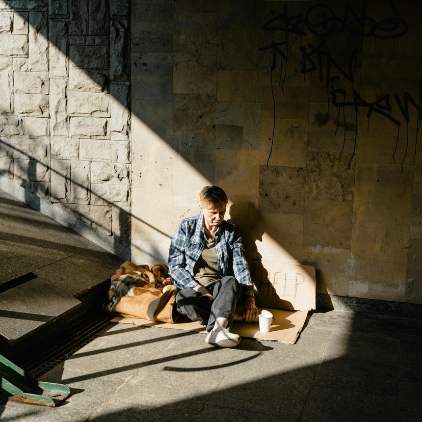 Homeless woman sitting on concrete floor