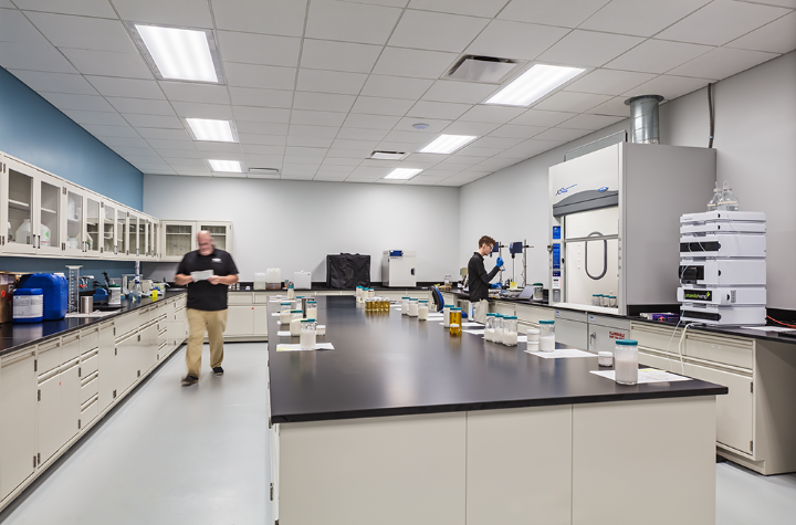 A large laboratory with two male workers