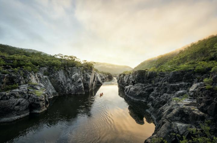 Events and News A solo paddler travelling along a river gorge