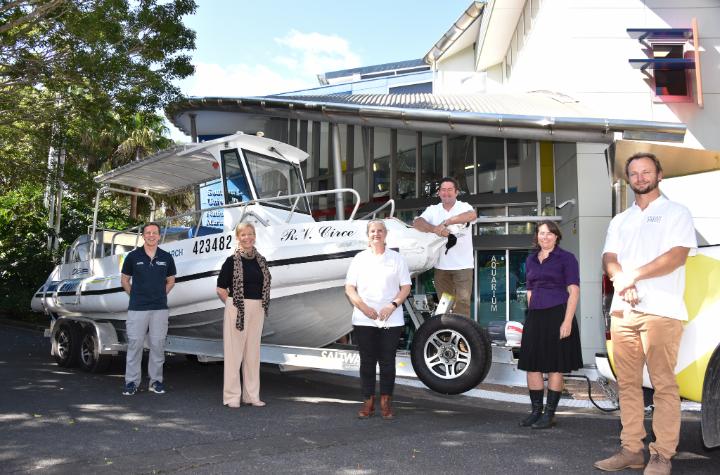 Events and News A group of 6 people standing alongside a vessel called RV Circe