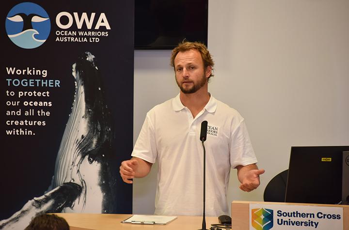 Events and News Man in white polo shirt making a presentation