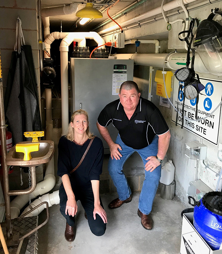 Woman and man in pump area of swimming pool