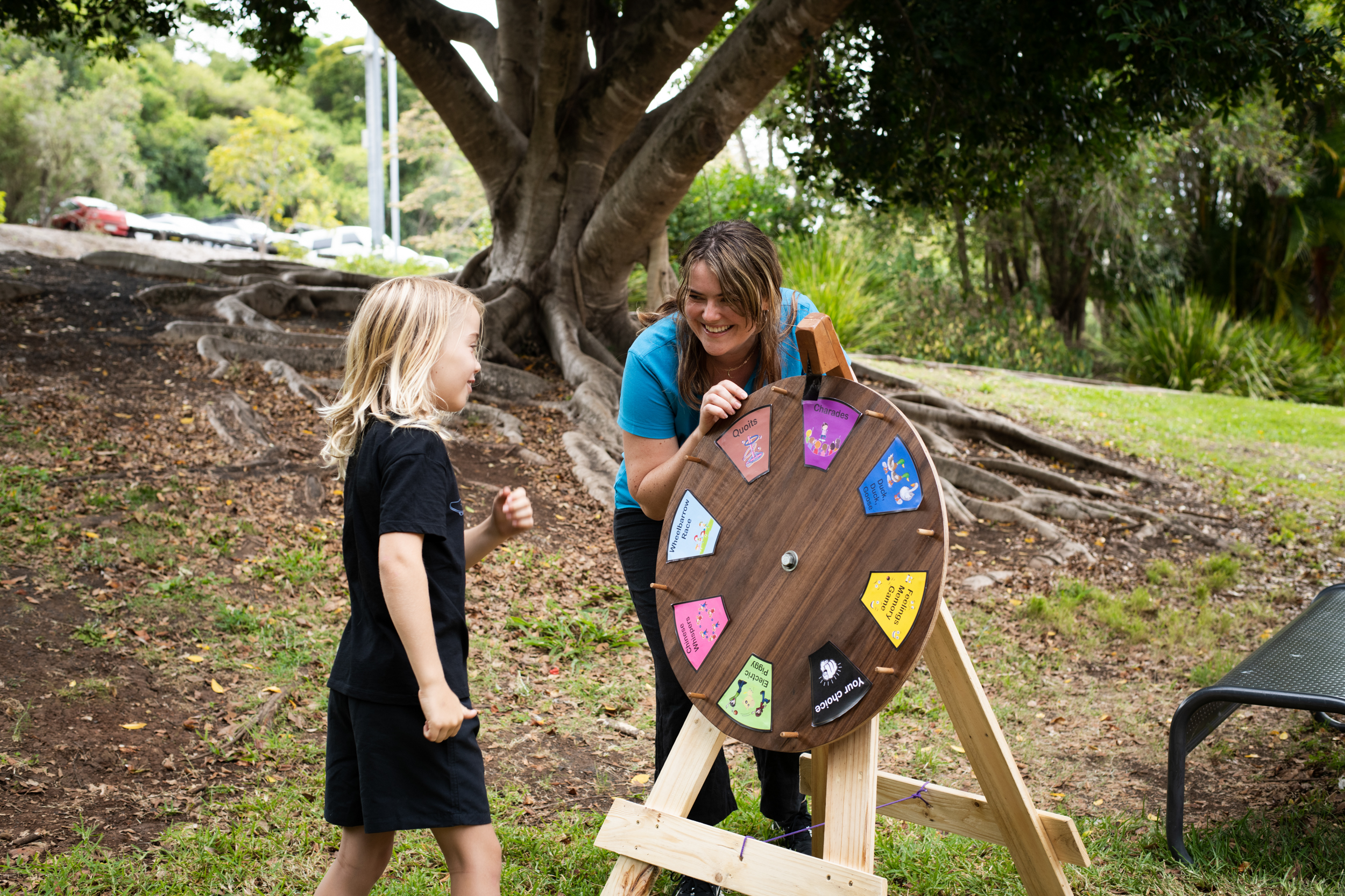 Student with OT student using wooden game spinner